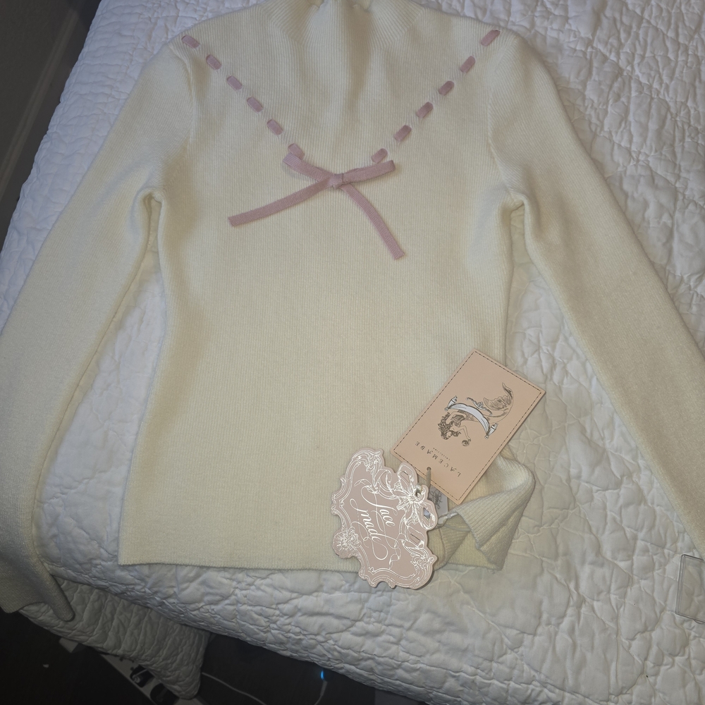 Chic Cream Turtleneck Sweater with Pink Details